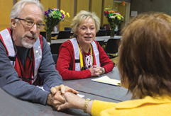 A photo of Erika Cunningham being comforted by two Red Cross workers at a shelter in Santa Rosa.